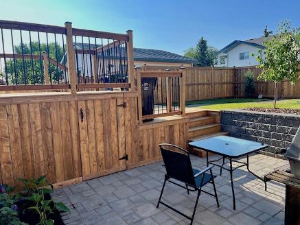 Deck, patio & retaining wall construction in Calgary backyard