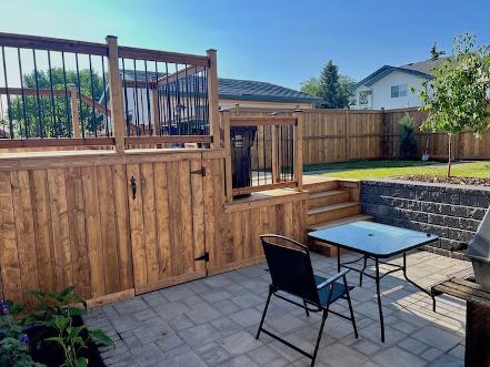 Deck, patio & retaining wall construction in Calgary backyard
