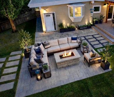 Paving stone patio with firepit and pergola construction in Calgary backyard