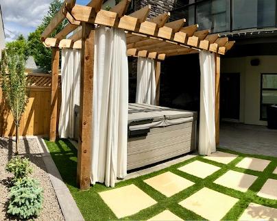 Hot tub area with pergola construction in Calgary backyard