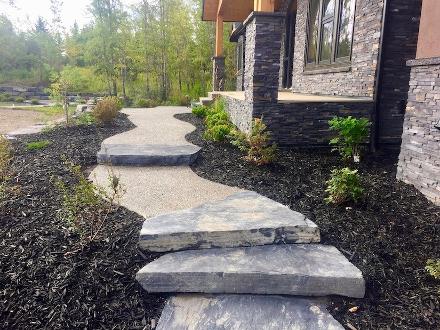 Natural stone steps and walkway construction in Calgary front yard