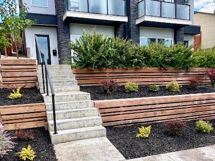 Tiered wood retaining wall construction in Calgary front yard