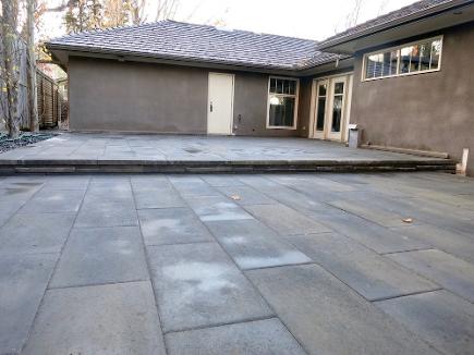Large paving stone patio build in Calgary backyard