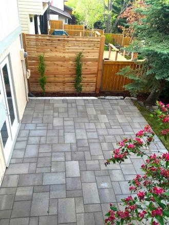 Paving stone patio construction in Calgary yard
