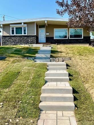 Front yard landscaping with new steps to entrance