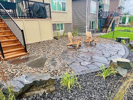Flagstone and natural rock landscaping in Cochrane backyard