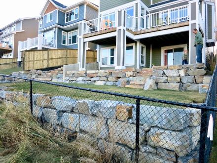 Tiered Natural rock retaining wall in Cochrane backyard