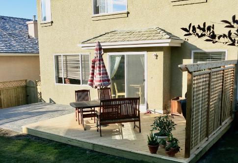 Wood deck and paving stone patio construction in Calgary backyard
