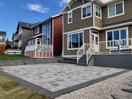 Paving stone patio construction in Calgary backyard