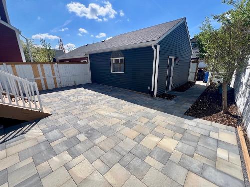Paving stone slab patio construction in Calgary backyard